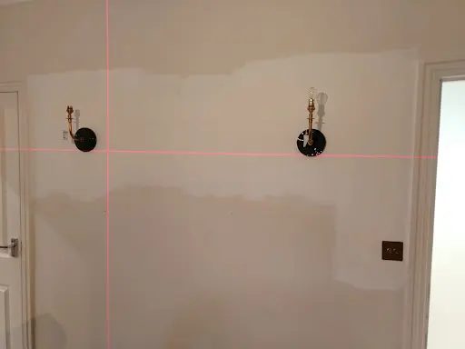 Wall light installation checked level in Hackney